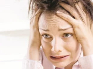 девушка держится за голову